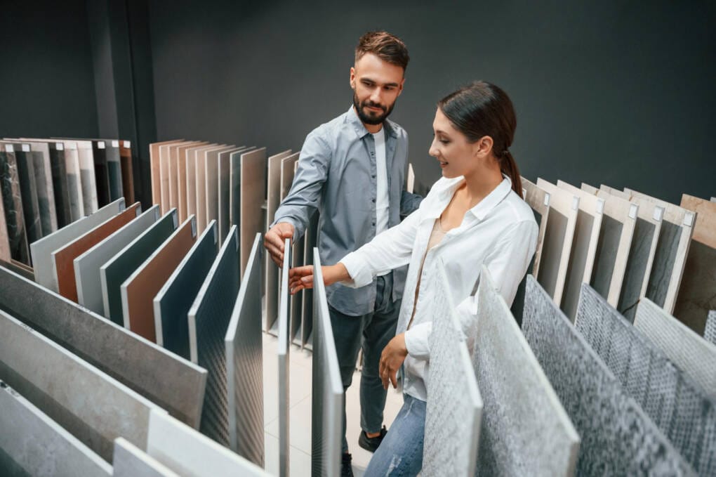Couple comparing porcelain tile samples at a Perth tile store