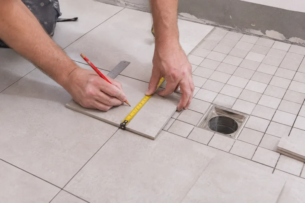 Ceramic tile sizes planned around bathroom cuts and floor waste