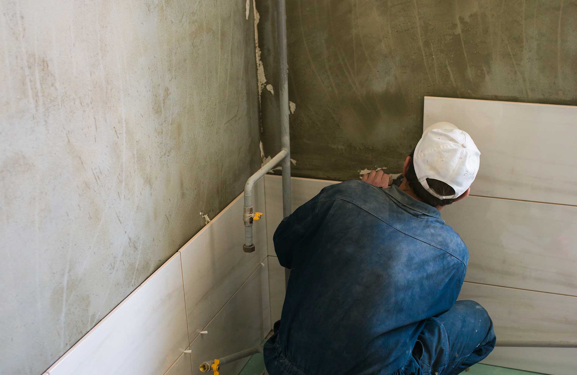 Tiling over rendered brick wall