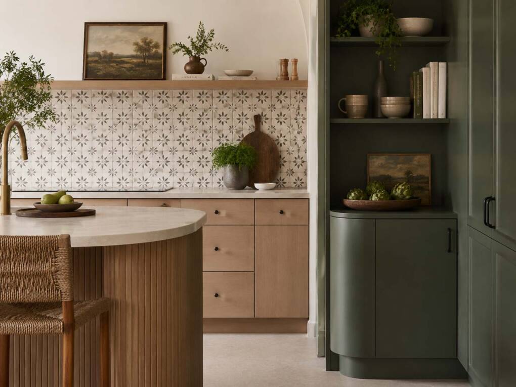 Kitchen renovation with bold feature tiles, coloured cabinetry and warm character