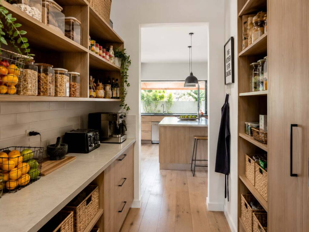 Walk-in pantry with organised shelving, pantry cupboards and warm kitchen storage
