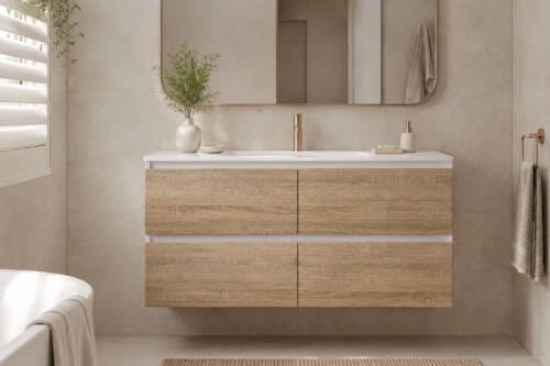Floating timber-look bathroom vanity with a white basin top, warm neutral tiles and brushed metal tapware