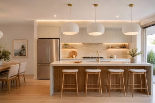 Modern Australian kitchen with three statement pendant lights, warm LED strips and natural timber island detail