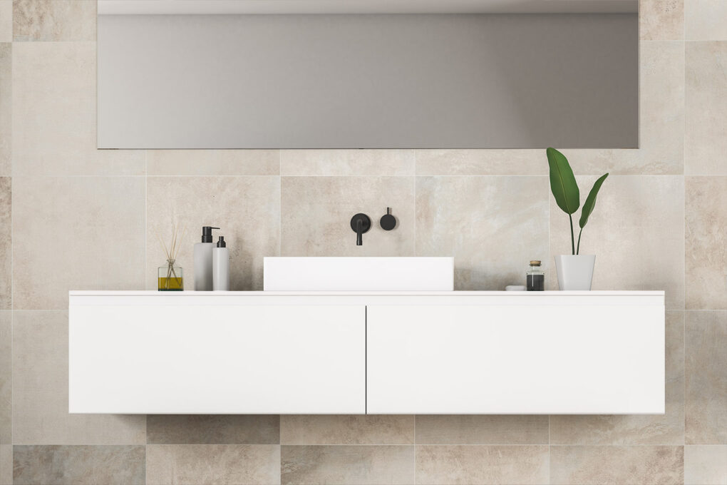 Modern floating vanity with a single basin, matte black wall-mounted tapware, and a large mirror, set against a neutral-toned tiled bathroom wall.