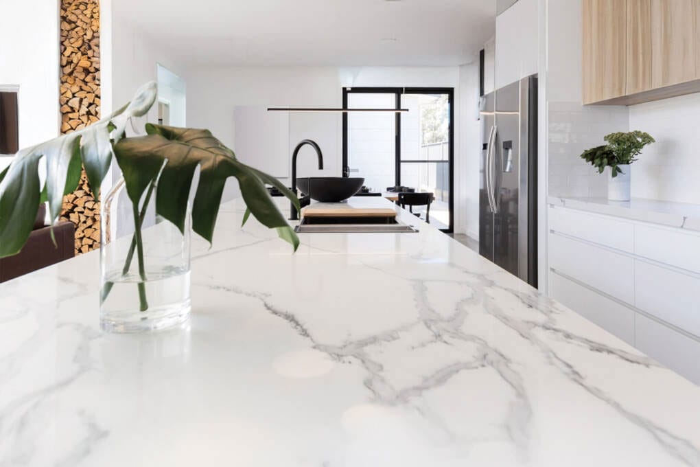 Modern Calacatta quartz stone kitchen benchtop with subtle grey veins enhancing a bright interior.