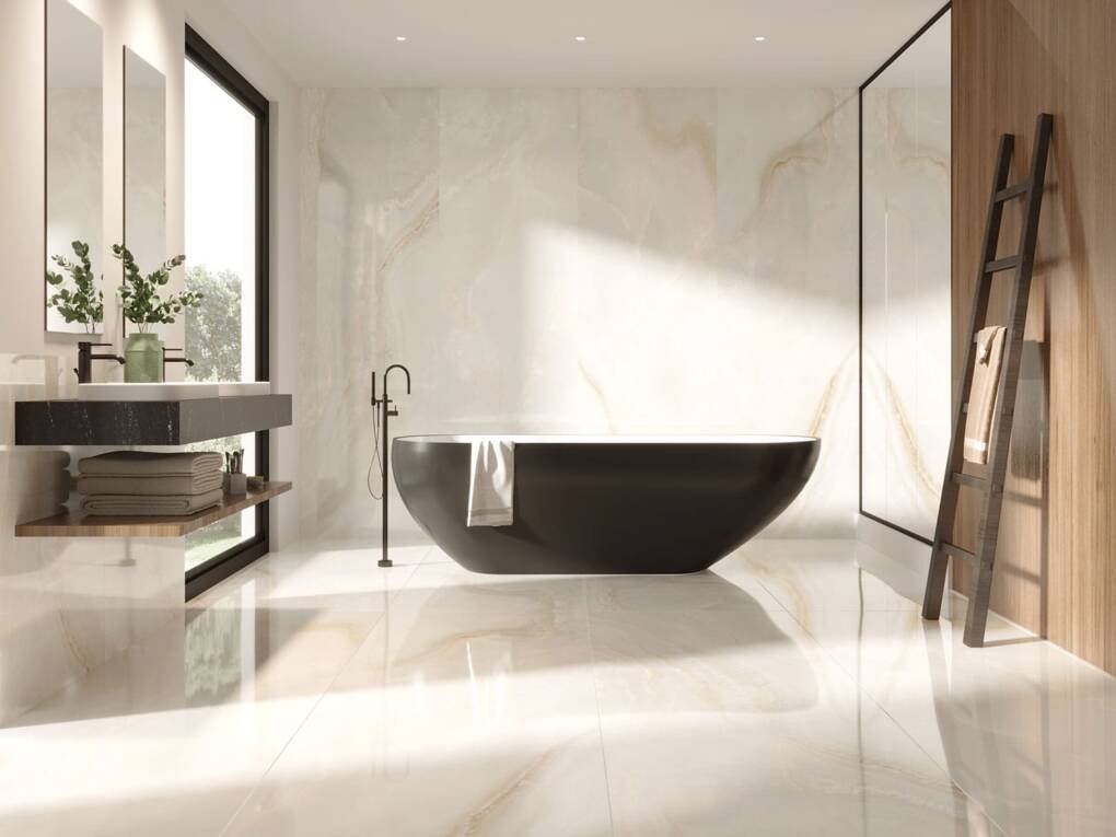 Soft warm-toned marble-look tiles in a contemporary bathroom with freestanding tub