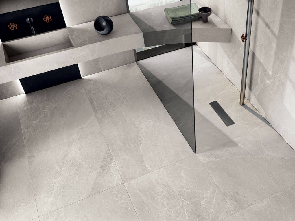 Grey marble-look tiles on bathroom floor and shower base with seamless finish