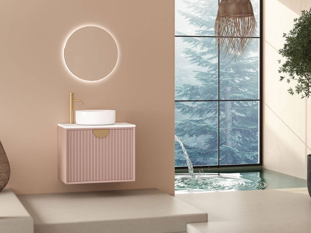 Minimalist bathroom with soft blush pink wall and white round mirror with floating vanity