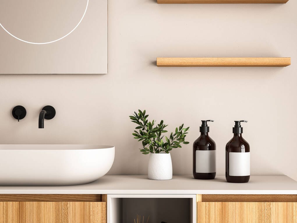 Wall-mounted matte black bathroom mixer tap above round basin on timber vanity