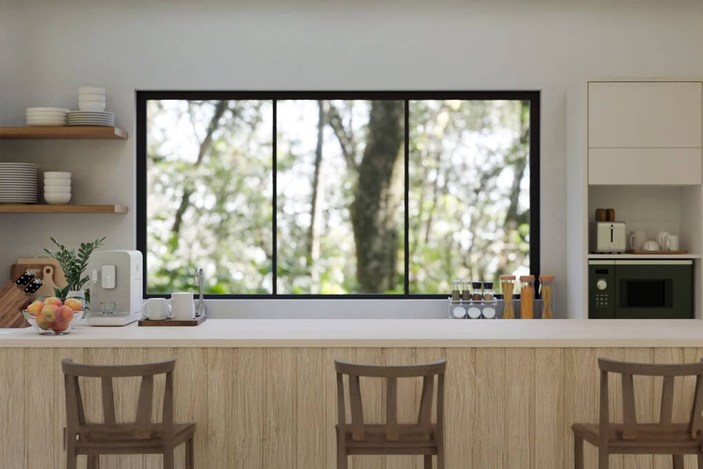 Black frame sliding windows in modern kitchen with outdoor view.
