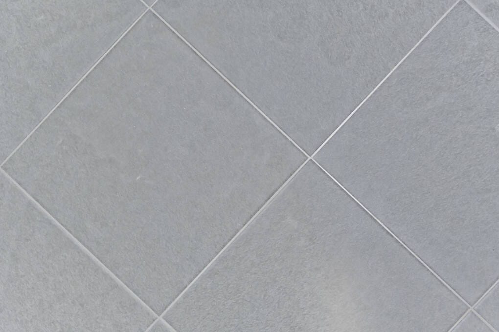 Pressed edge tiles with rounded cushioned edges installed on a floor