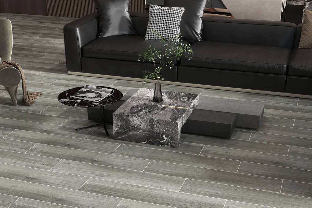 Modern living room with stylish wood look tile flooring and black leather sofa