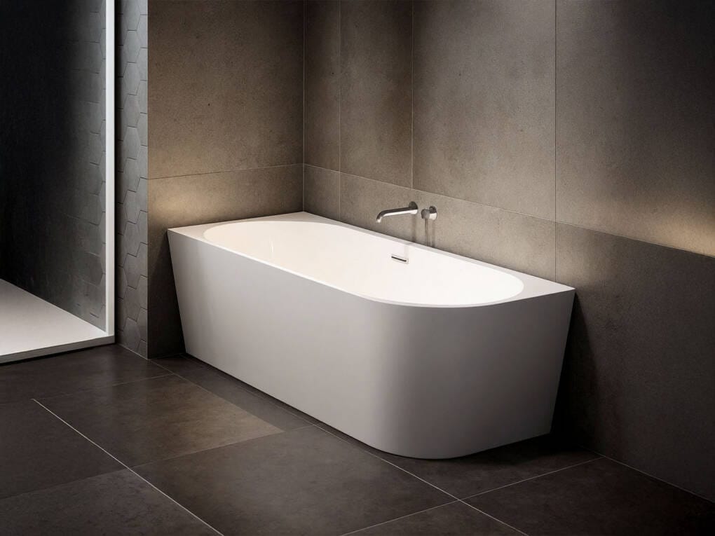 right hand freestanding corner bath in modern bathroom with dark tiles and wall mounted tap