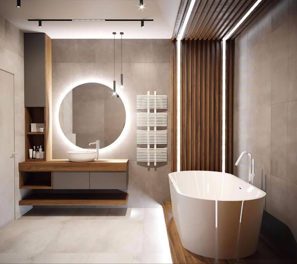 luxury bathroom design with a freestanding bath, led mirror and stone-look tiles