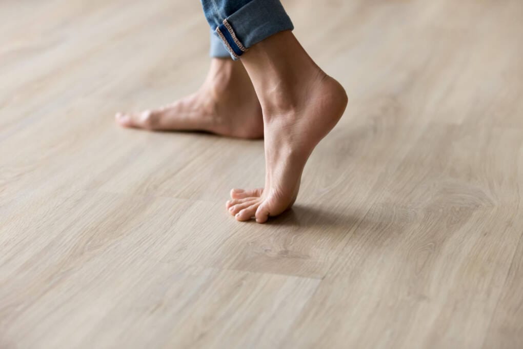feet walking on timber flooring to show durability