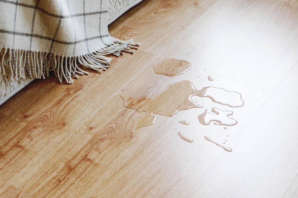 spilt water on timber flooring to show water resistance