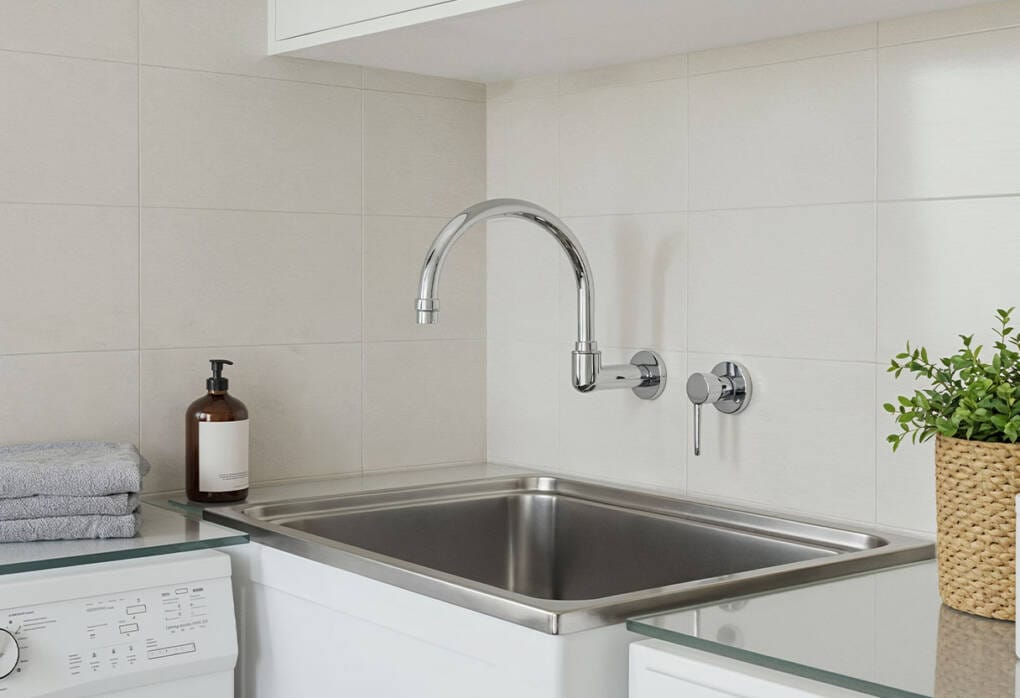Wall-mounted swivel laundry spout and mixer above deep tub in compact Perth laundry