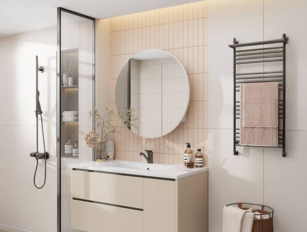 Round bathroom mirror cabinet above modern vanity with soft peach feature tiles and matte black tapware in Perth bathroom