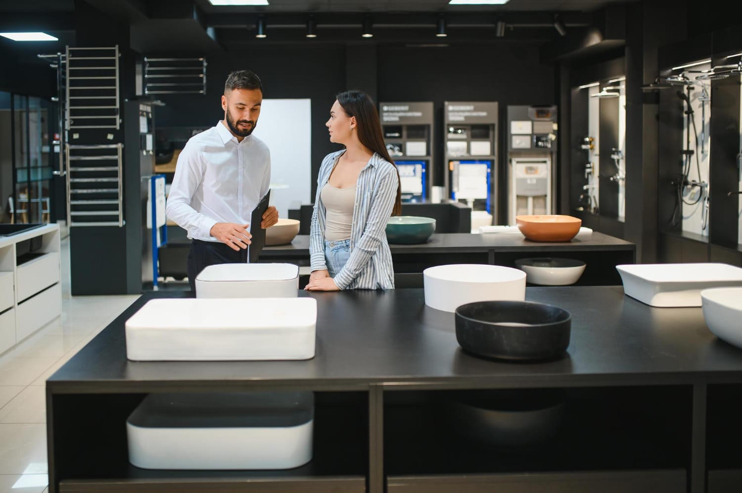 Customer discussing bathroom basin options with an expert at a Perth bathroom store, highlighting local experience and trusted service