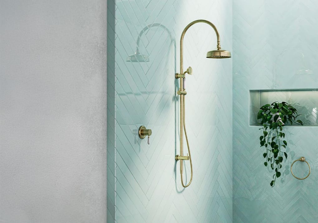 Gold dual shower system with overhead rainfall shower and handheld shower in a modern bathroom.