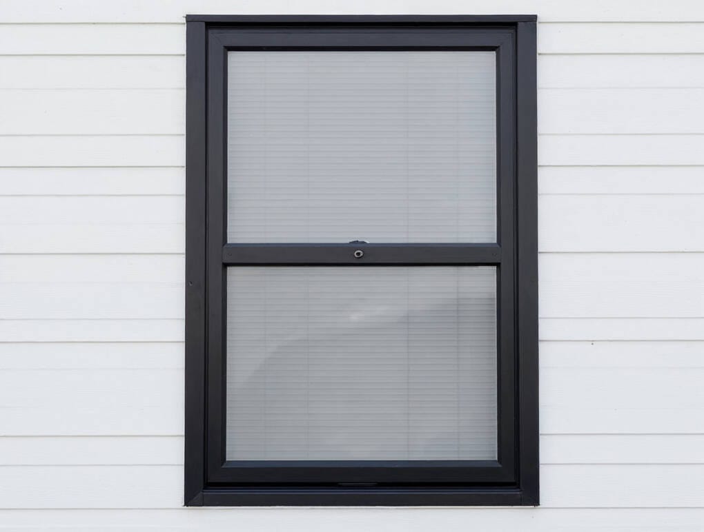 Black framed double hung window exterior close up