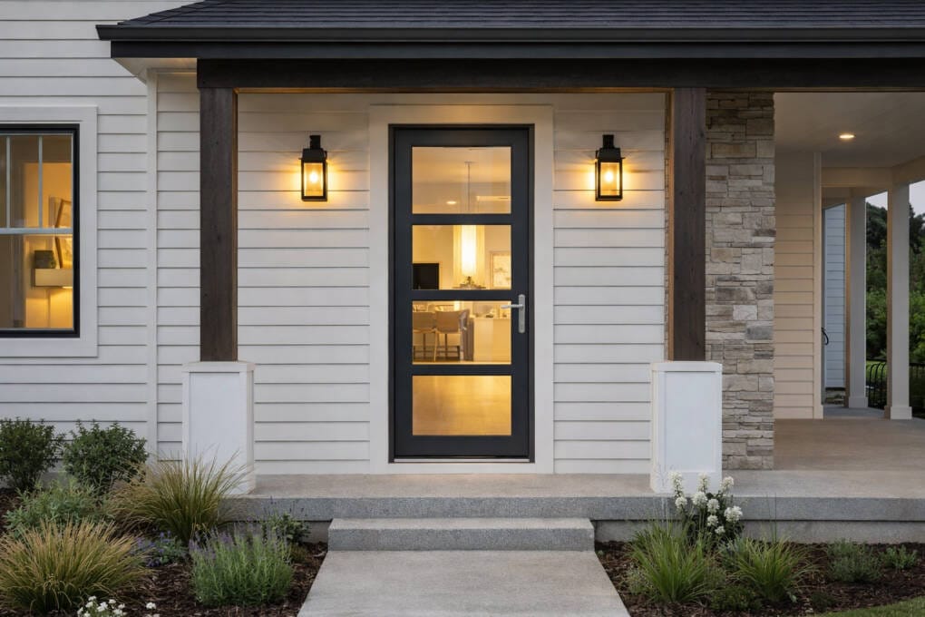 Aluminium glass front door with black frame in a weatherboard home entryway