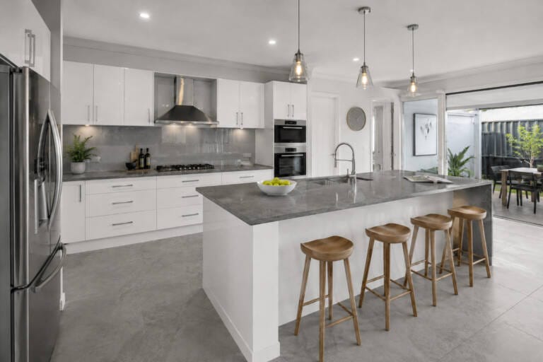 Modern grey and white kitchen with glossy white cabinets, grey benchtop, grey splashback and grey floor tiles