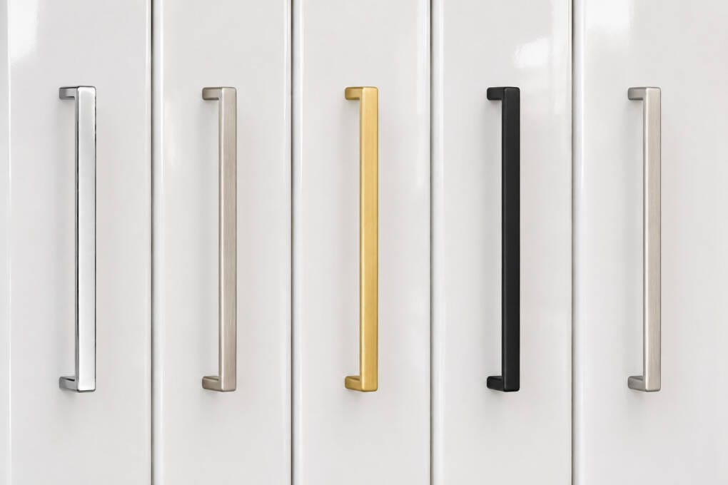 Matte black, brushed gold and brushed nickel handles compared on high-gloss white cabinet fronts