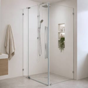 Frameless corner shower screen with pivot door and return panel in a Perth bathroom